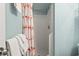 Clean shower stall with a flamingo-themed curtain and fresh white towels at 609 Hillside Dr. S # C-16, North Myrtle Beach, SC 29582