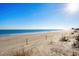Expansive view of a sunny beach with gentle waves, offering a serene and inviting atmosphere at 617 Hibiscus Ave. # 617, Myrtle Beach, SC 29577