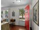 Bright entryway featuring hardwood floors, a striking red door, and abundant natural light from surrounding windows at 617 Hibiscus Ave. # 617, Myrtle Beach, SC 29577