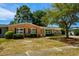 Single-story home with brick and siding, complemented by mature trees and established landscaping at 617 Hibiscus Ave. # 617, Myrtle Beach, SC 29577