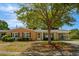 Charming single-story brick home with a covered carport and a lush green lawn at 617 Hibiscus Ave. # 617, Myrtle Beach, SC 29577