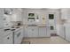 Well-lit kitchen with white appliances, cabinetry, and a window overlooking the fenced backyard at 617 Hibiscus Ave. # 617, Myrtle Beach, SC 29577