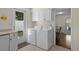 This laundry room features white cabinets and a door that leads to the backyard at 617 Hibiscus Ave. # 617, Myrtle Beach, SC 29577