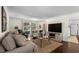 Open-concept living room featuring hardwood floors, comfortable seating, and a view into the kitchen at 617 Hibiscus Ave. # 617, Myrtle Beach, SC 29577