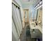Bright bathroom features a double sink vanity, and a shower with a white curtain at 625 North Waccamaw Dr. # 101, Murrells Inlet, SC 29576