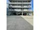 A multi-level condo building showcasing elevated construction and private covered parking at 625 North Waccamaw Dr. # 101, Murrells Inlet, SC 29576