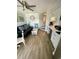 Compact living room features laminate flooring, and flows into a well-lit kitchen with sleek white cabinets at 625 North Waccamaw Dr. # 101, Murrells Inlet, SC 29576