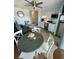 Cozy living room area with laminate flooring, a ceiling fan, and stainless steel appliances in a compact kitchen at 625 North Waccamaw Dr. # 101, Murrells Inlet, SC 29576