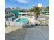 Inviting community pool with lounge chairs, pergola and landscaping, near Whispering Sands sign at 625 North Waccamaw Dr. # 101, Murrells Inlet, SC 29576