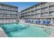 Beautiful community pool surrounded by inviting lounge chairs and attractive buildings at 625 North Waccamaw Dr. # 101, Murrells Inlet, SC 29576
