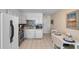 This bright kitchen has white cabinets, stainless appliances, a tile backsplash, and an adjacent cozy dining area at 6302 N Ocean Blvd. # G-3, North Myrtle Beach, SC 29582