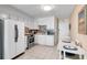Bright kitchen with white cabinets, stainless steel appliances, and tile backsplash, adjacent to cozy dining area at 6302 N Ocean Blvd. # G-3, North Myrtle Beach, SC 29582
