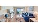 Comfortable living room with ocean-themed decor, hardwood floors, and access to a private balcony at 6302 N Ocean Blvd. # G-3, North Myrtle Beach, SC 29582