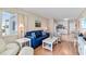 Inviting living room with blue sofa, white furniture, and art, flowing into the kitchen and dining space at 6302 N Ocean Blvd. # G-3, North Myrtle Beach, SC 29582