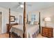 Traditional bedroom with a four-poster bed, dresser, side tables and neutral tones at 6302 N Ocean Blvd. # G-3, North Myrtle Beach, SC 29582