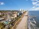 Aerial view of the Myrtle Beach coastline, featuring the SkyWheel, sandy beach, and oceanfront hotels at 6734 Blue Heron Blvd. # 104, Myrtle Beach, SC 29588