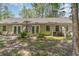 Large backyard featuring a covered patio, landscaping and rear exterior of home at 6734 Blue Heron Blvd. # 104, Myrtle Beach, SC 29588