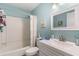 Bright bathroom with blue walls, white cabinets, shower and tub combination, and a modern sink at 6734 Blue Heron Blvd. # 104, Myrtle Beach, SC 29588