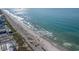 Expansive aerial view of the coastline, showcasing the wide sandy beach and clear blue ocean waters at 6734 Blue Heron Blvd. # 104, Myrtle Beach, SC 29588