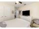 Bedroom with ceiling fan, TV atop a white dresser, closet and comfortable armchair at 6734 Blue Heron Blvd. # 104, Myrtle Beach, SC 29588
