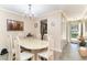 Bright dining area with wood-look floors, a view of the front yard and doorway access to kitchen at 6734 Blue Heron Blvd. # 104, Myrtle Beach, SC 29588