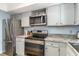 Updated kitchen featuring stainless steel appliances, granite countertops and white cabinets at 6734 Blue Heron Blvd. # 104, Myrtle Beach, SC 29588