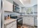 Functional kitchen features stainless steel appliances, granite countertops and ample storage space at 6734 Blue Heron Blvd. # 104, Myrtle Beach, SC 29588