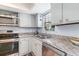 Efficient kitchen with granite countertops, stainless steel appliances, and a double sink by the window at 6734 Blue Heron Blvd. # 104, Myrtle Beach, SC 29588