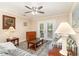 Comfortable living room with striped sofas, area rug and a view to the wooded backyard at 6734 Blue Heron Blvd. # 104, Myrtle Beach, SC 29588