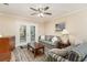 Cozy living room area with sofas, ceiling fan and glass patio doors at 6734 Blue Heron Blvd. # 104, Myrtle Beach, SC 29588