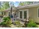 Back patio featuring a patio table with umbrella and other outdoor seating surrounded by landscaping at 6734 Blue Heron Blvd. # 104, Myrtle Beach, SC 29588