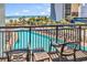Balcony with chairs overlooking a sparkling pool, palm trees and the ocean at 7100 N Ocean Blvd. # 317, Myrtle Beach, SC 29572