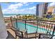 Balcony with chairs overlooking a sparkling pool, palm trees and the ocean at 7100 N Ocean Blvd. # 317, Myrtle Beach, SC 29572