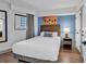Cozy bedroom featuring a comfortable bed, window and vibrant wall art at 7100 N Ocean Blvd. # 317, Myrtle Beach, SC 29572