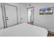 Minimal bedroom featuring a white bed and door to hallway with mounted television at 7100 N Ocean Blvd. # 317, Myrtle Beach, SC 29572