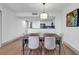 Dining room with modern table setting and open view to the kitchen at 7100 N Ocean Blvd. # 317, Myrtle Beach, SC 29572