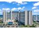 Beautiful exterior of a condo building with a blue sky background at 7100 N Ocean Blvd. # 317, Myrtle Beach, SC 29572