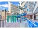 Exterior view of a waterpark with blue waterslides, pool and palm trees at 7100 N Ocean Blvd. # 317, Myrtle Beach, SC 29572