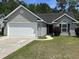 Charming single-story home with gray siding, attached garage, and well-maintained lawn at 753 Bucklin Loop, Myrtle Beach, SC 29579