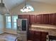 Kitchen featuring stainless steel appliances, dark cabinets and a bright arched window at 753 Bucklin Loop, Myrtle Beach, SC 29579