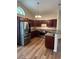 Well-lit kitchen boasts stainless steel appliances, dark cabinets, and a peninsula at 753 Bucklin Loop, Myrtle Beach, SC 29579