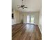 Bright living room featuring hardwood floors, ceiling fan, and double glass doors at 753 Bucklin Loop, Myrtle Beach, SC 29579