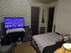 Bedroom featuring a television, floral wallpaper, and a cozy bed at 8 Ryan Ln., Myrtle Beach, SC 29579