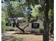 Charming single-story home with white siding, green shutters, and mature trees in a peaceful setting at 8 Ryan Ln., Myrtle Beach, SC 29579