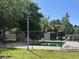 Community pool surrounded by a secure fence and shaded by mature trees at 8 Ryan Ln., Myrtle Beach, SC 29579