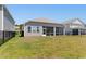 Exterior of home showing fenced backyard, screened porch and landscaped lawn at 8077 Fort Hill Way, Myrtle Beach, SC 29579