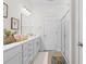 Bathroom with a double vanity, framed mirror, shower with glass doors, and white cabinets at 8077 Fort Hill Way, Myrtle Beach, SC 29579