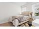 Neutral bedroom with a full size bed, side table, cowhide rug, and natural light at 8077 Fort Hill Way, Myrtle Beach, SC 29579