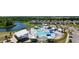 Aerial shot of a community pool area with a splash pad, lounge chairs, and a clubhouse at 8077 Fort Hill Way, Myrtle Beach, SC 29579