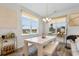 The dining area features a large window, stylish chandelier, and modern decor at 8077 Fort Hill Way, Myrtle Beach, SC 29579